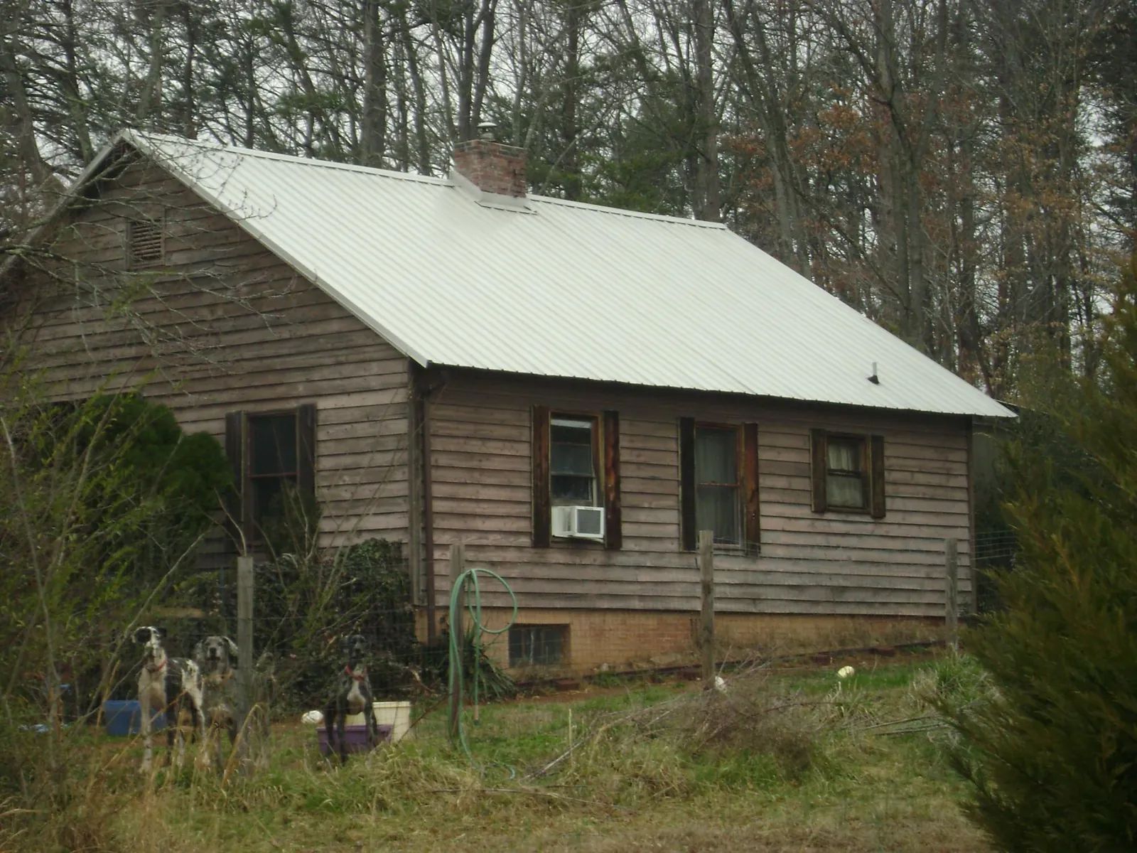 White metal roof on an old wood sided farmhouse, from a Metal Roof Installation job in Cheyney